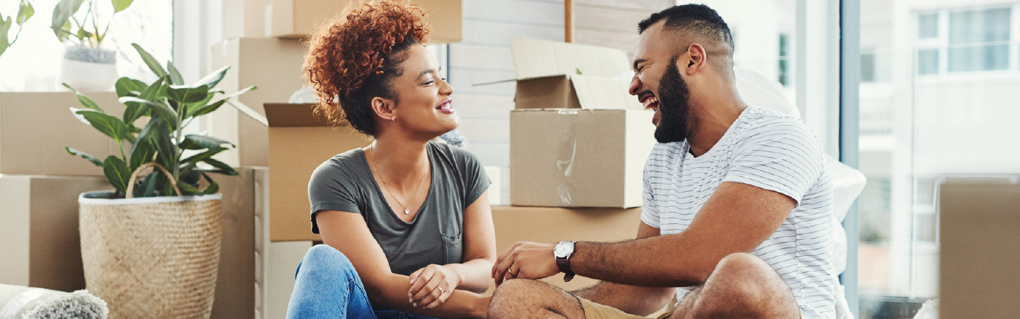 A couple surrounded by moving boxes