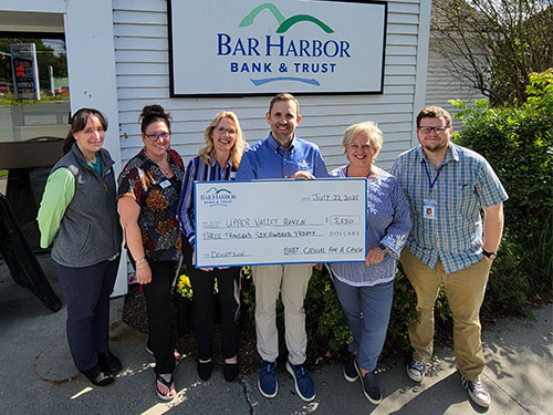 BHBT employees present a donation to Upper Valley Haven