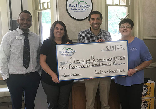 BHBT employees present a check to Changing Perspectives