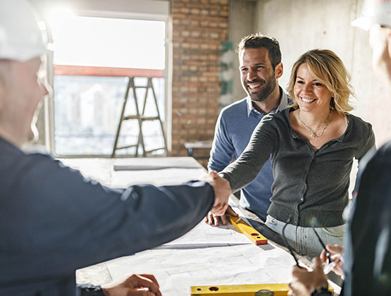 Couple meeting with contractors in home