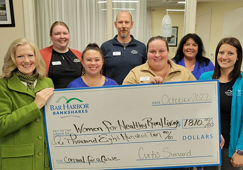 BHBT employees present a check to Women for Healthy Rural Living