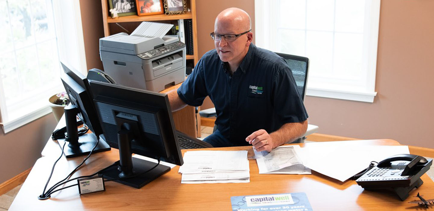 A business owner looks at his computer