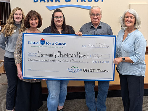 BHBT employees present a donation to the Community Christmas Project