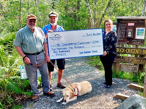 BHBT employee presents a donation to New London Conservation Commission