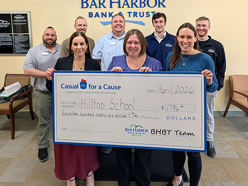 BHBT employees present a donation to Hilltop School