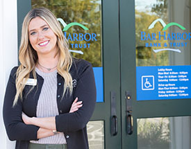 Smiling woman standing in front of the Bank