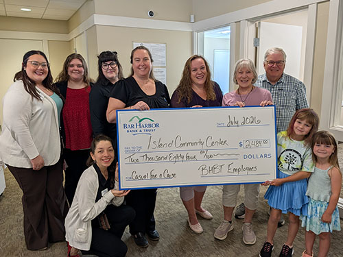 BHBT employees present a donation to Island Community Center