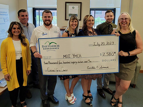 BHBT employees present a donation to Mount Desert Island YMCA