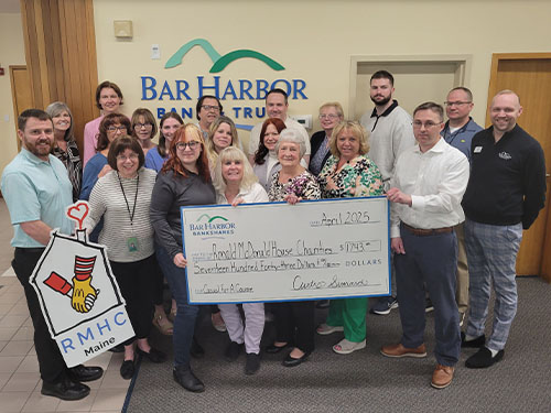 BHBT employees present a donation to Ronald McDonald House Charities of Maine