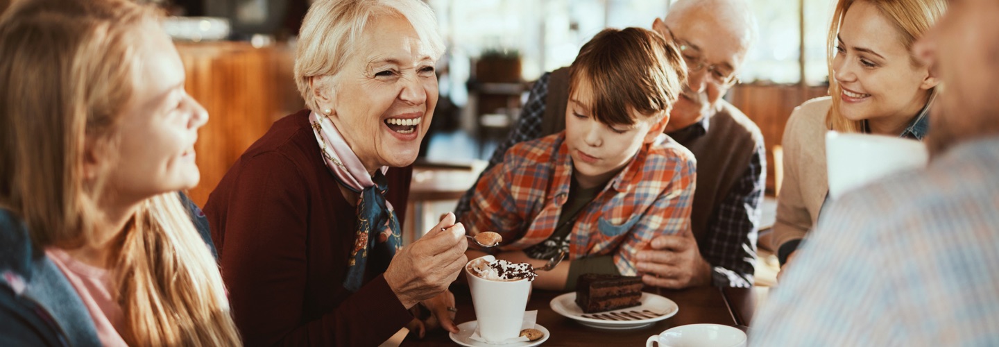 A large family eating together at a cafe.