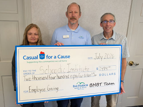 BHBT employees present a donation to Schoodic Institute