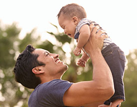 A man holding his son in the air