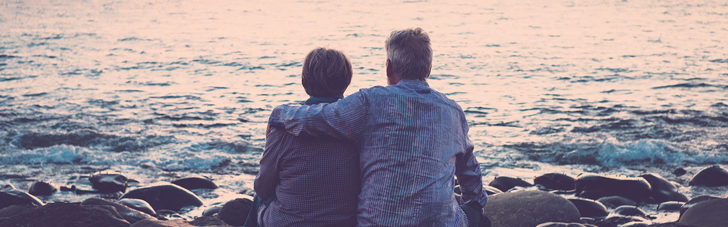 Couple sitting on the shore