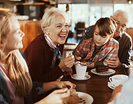 Image of older woman laughing with her family
