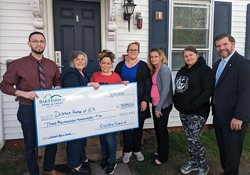 BHBT employees present a donation to Dismas Home