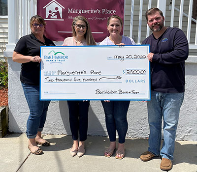 BHBT employees present a check to Marguerite's Place